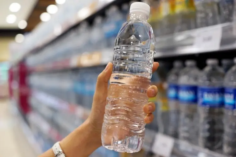 Tourist buying bottled water in Cancun for health safety