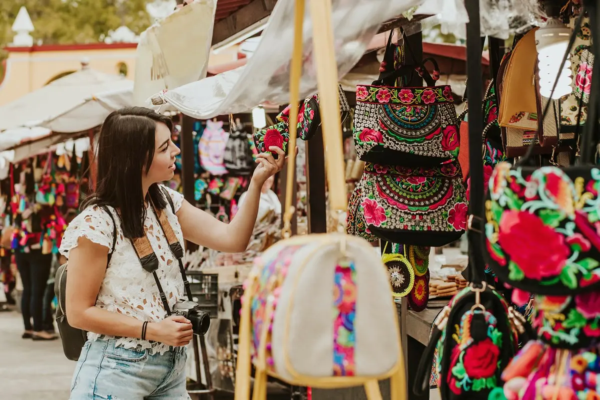 Tourist shopping for souvenirs in Cancun, avoiding overpriced items