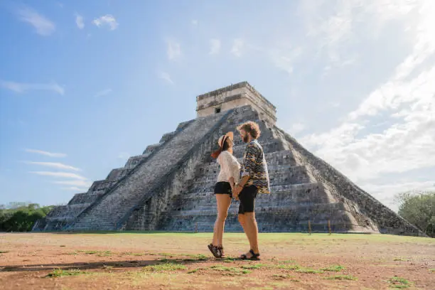 Couple exploring Chichen Itza on their Cancun honeymoon